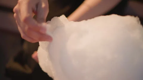 Night vendor crafting, Sugar clouds formed by fingers, Artist shaping sweet Stock Footage 327661724