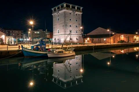 Night view of ancient bricks tower on port channel in Cervia - Emilia Romagna Foto stock