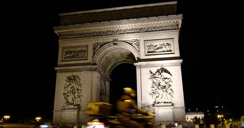 Night view of the Arc de Triomphe in Paris, majestic architecture and traffic Stock Footage 329171178