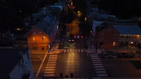 Night view of a bus crossing an intersection in an American city. Aerial Stock Footage 258349120