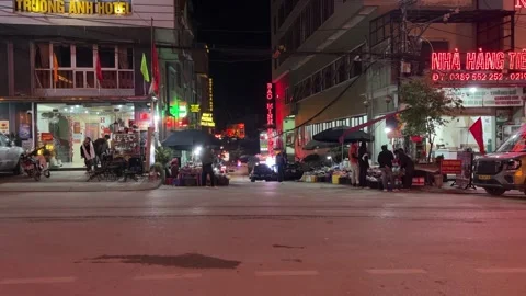Night View of Busy Town Intersection With Neon Signs in Yen Minh Ha Giang Stock Footage 335970295