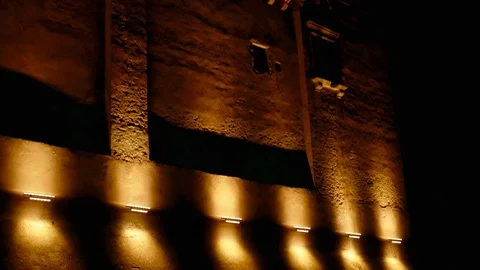 Night view of a castle with light beam and the moon - Pan Stock Footage 90294718