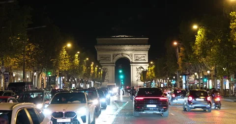 Night view of Champs-Elysees in Paris with Arc de Triomphe and urban traffic Stock Footage 329174082