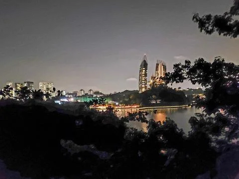 Night view of city skyline reflected in calm water Stock Photos