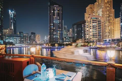 Night View Of City Skyline From Tourist Boat, Sightseeing Boat Sailing On Dubai Stock Photos
