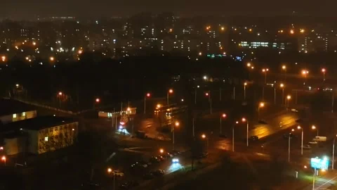 Night view of city streets with lights and cars in motion from a tall building Stock Footage 326697476