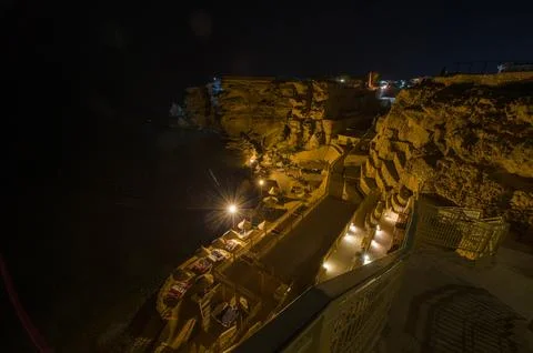 Night view of cliffside resort with warm lighting Stock Photos