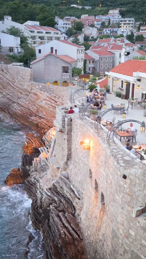 Night view of coastline, sea, cliffs, old city buildings and restaurant Stock Footage 280997083