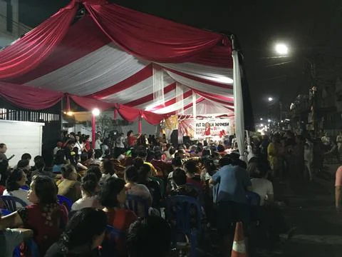 Night View of Crowd Gathered Under Red White Canopy Stock Photos