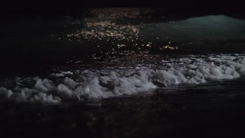 Night view of the dark sea waves rolling in on the shore Stock Footage