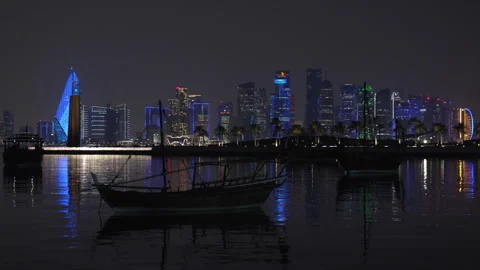 Night view of Doha's illuminated West Bay skyline behind the '7' Sculpture. Stock Footage 344875126