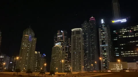Night view of Dubai Sheikh Zayed Street skyscrapers while driving on Highway. Stock Footage