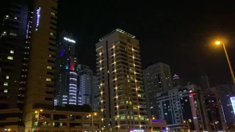 Night View of Dubai Towers While Driving Car On The Highway . Stock Footage 145961662