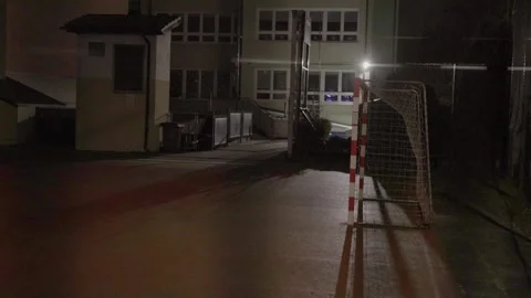 Night view of an empty school sports field creating an abandoned and quiet Stock Footage 324834640