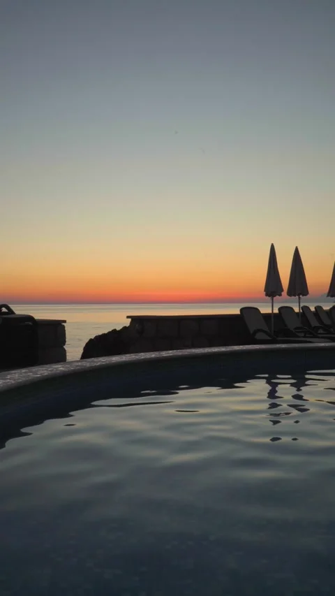 Night view of empty swimming pool and closed beach umbrellas Stock Footage 280996672