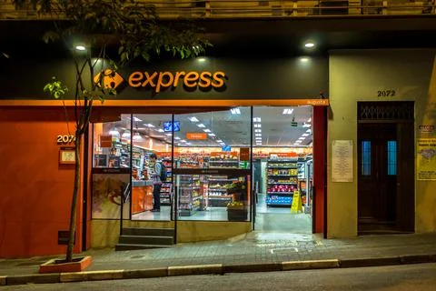 Night view of facade of Carrefour Express store in Augusta streeet Stock Photos