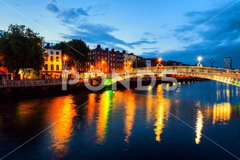 Night view of famous illuminated Ha Penny Bridge in Dublin, Ireland Stock Photos
