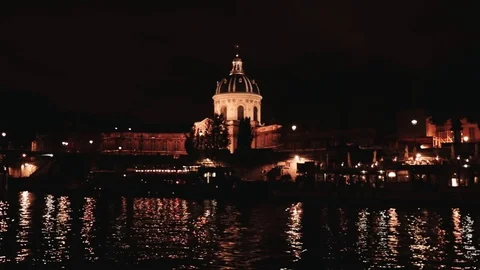 Night view of a floating ship sailing along the Seine River at the Paris Academy Stock Footage 128686173