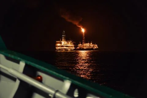Night view of FPSO tanker vessel near Oil Rig. Stock Photos