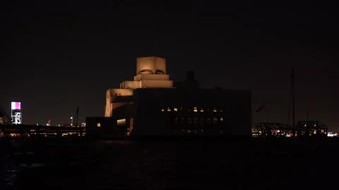 Night View of the Illuminated Museum of Islamic Art and Dhow Boats Stock Footage 336923535
