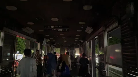 The night view inside a TransJakarta bus stop during a power outage. Stock-Footage 333809539