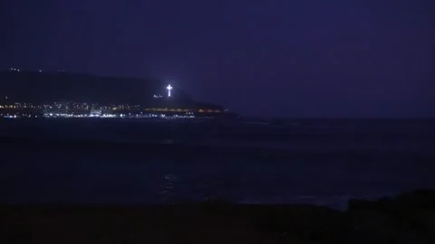 Night view of the lights of a small town and cross near the sea in Lima, Peru. Stock Footage 333018777