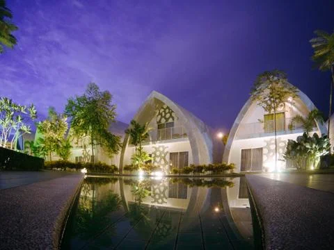 Night view at low angle pool of chic and street art hotel building (dash box) 写真素材