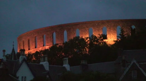 Night view of McCaig's Tower over the hill in Oban Stock Footage 39392655