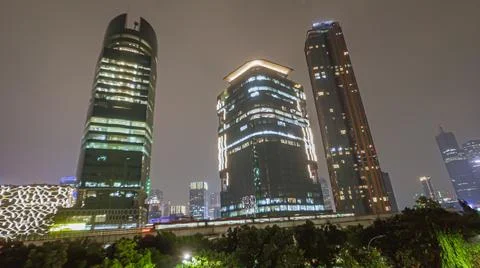 A night view of a modern train passing through the elevated railways in the city Stock Photos