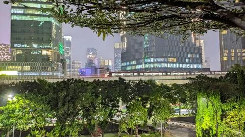 A night view of a modern train passing through the elevated railways in the city Stock Photos