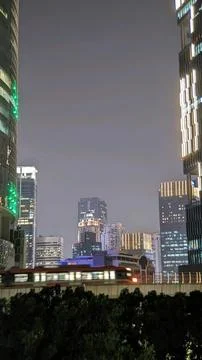 A night view of a modern train passing through the elevated railways in the city Stock Photos