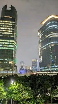 A night view of a modern train passing through the elevated railways in the city Stock Photos