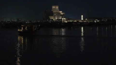 Night view of moving dhow boat and illuminated Museum of Islamic Art  Stock Footage 333633404
