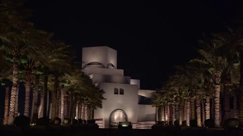 Night View of Museum of Islamic Art Framed by Palm Trees in Doha Stock Footage 337036524