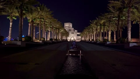 Night View of Museum of Islamic Art and Illuminated Palm Avenue in Doha Stock Footage 337036541