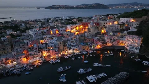 Night view of Procida old town and harbor in the bay of Napoli in Italy. Aerial Stock Footage 200703260