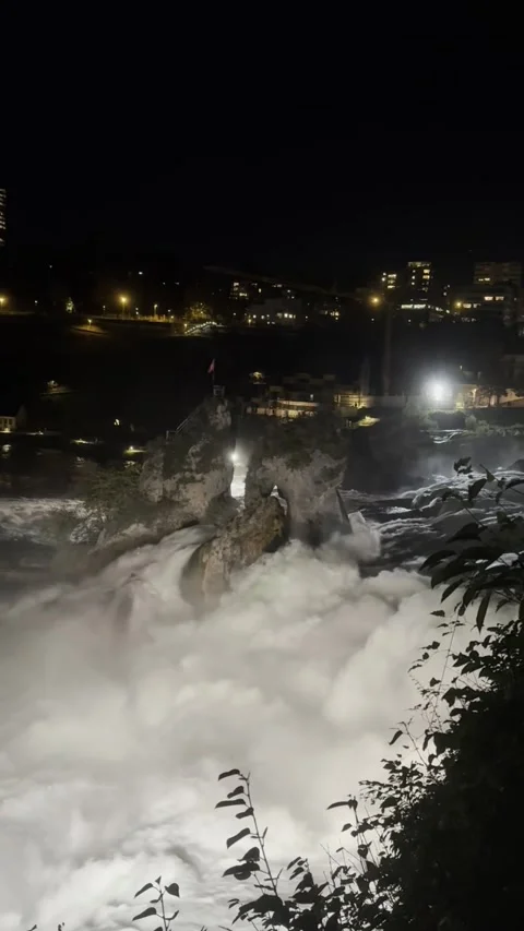 Night view of Rhine Falls area with illuminated riverside in Schaffhausen Stock Footage 338202270