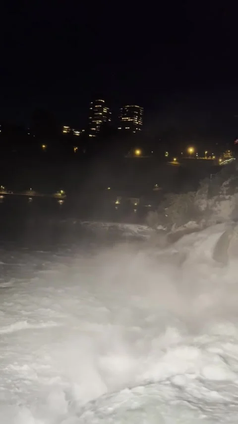 Night view of Rhine Falls area with illuminated riverside in Schaffhausen Stock Footage 338290401