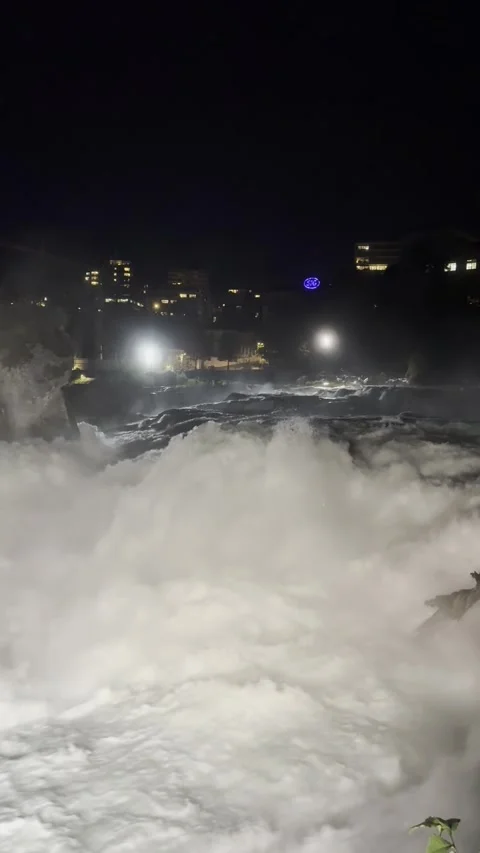 Night view of Rhine Falls area with illuminated riverside in Schaffhausen Stock Footage 338290407