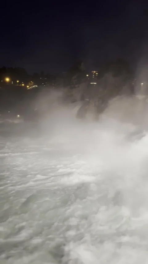 Night view of Rhine Falls area with illuminated riverside in Schaffhausen Stock Footage 338290409