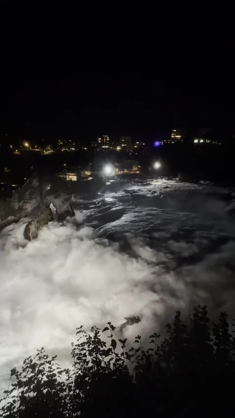 Night view of Rhine Falls area with illuminated riverside in Schaffhausen Stock Footage 338290412