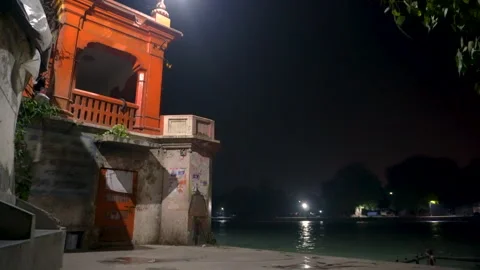 Night View of Riverside Temple in haridwar, india with Hindi ANNOUNCEMENT Poster Stock Footage 320468351