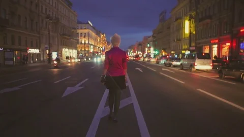 Night view of a road and backview of girl going at center of road Stock Footage 78815396