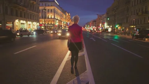 Night view of a road and backview of girl going at center of road Stock Footage 78815472
