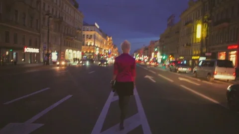 Night view of a road and backview of girl going at center of road Stock Footage 78815628