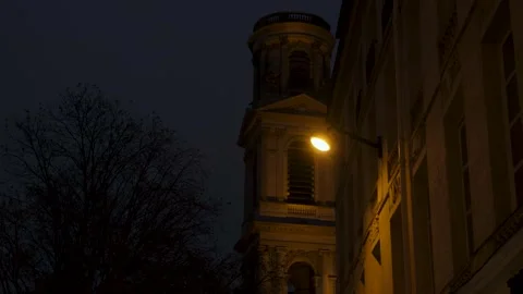 Night View of Saint-Sulpice Church Tower Illuminated from a Paris Street Stock Footage 319247061