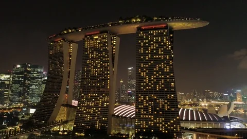 Night view Singapore skyline flying over Marina Bay Sands Hotel. Shot. Aerial Stock Footage