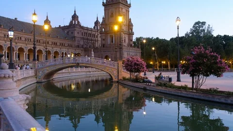 Night view of Spain Square (Plaza de Espana) with bridge reflecing in water Stock Footage 103086718