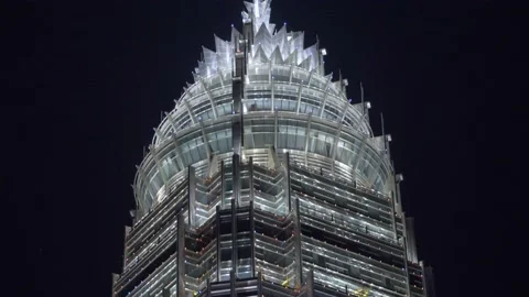 Night view of a spire-shaped modern skyscraper Stock Footage 156803527