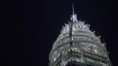 Night view of a spire-shaped modern skyscraper Stock Footage 156803857